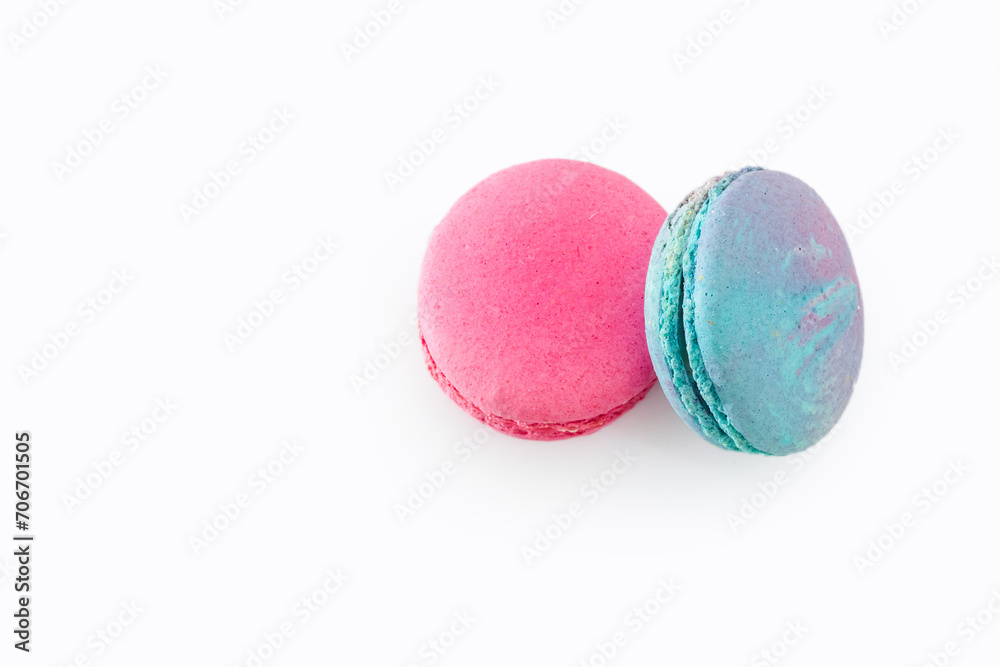 Tasty colorful macarons isolated on white background. Sweet macaroons dessert. Two multi-colored blue and pink macaroons. French pastry, almond cookies from egg whites. Tasty colorful macarons isolated on white background. Sweet macaroons dessert. Two multi-colored blue and pink macaroons. French pastry, almond cookies from egg whites.