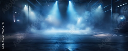 The dark stage shows  empty navy  indigo  midnight blue background  neon light  spotlights  The asphalt floor and studio room with smoke