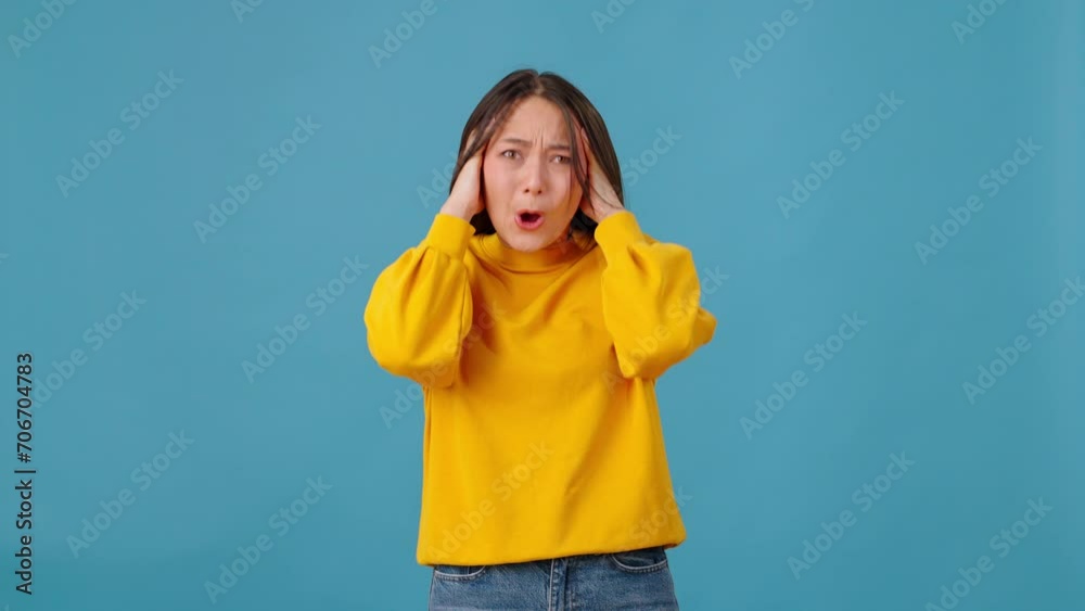 Anxious female shaking head and screaming in colorful studio Anxious female shaking head and screaming in colorful studio