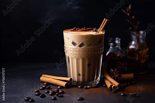 Ice coffee smoothie with cinnamon on a black background.