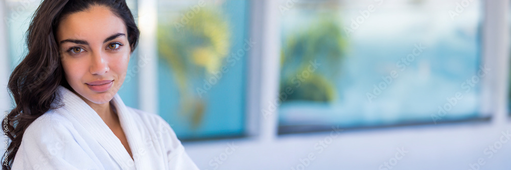 Portrait of a beautiful young woman in bathrobe at spa center Portrait of a beautiful young woman in bathrobe at spa center