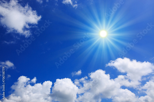Blue sky background with sunlight and white clouds. Nature summer background.