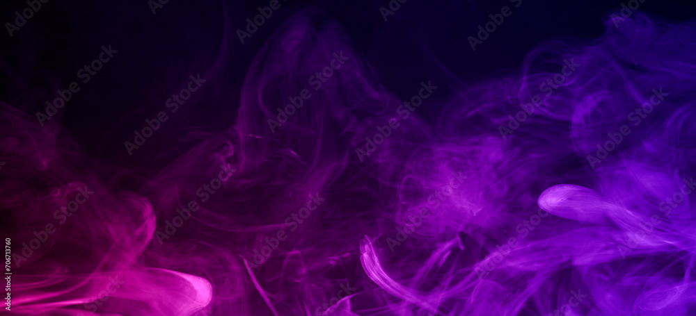 Clouds of smoke of magenta and purple colors mixed against black background