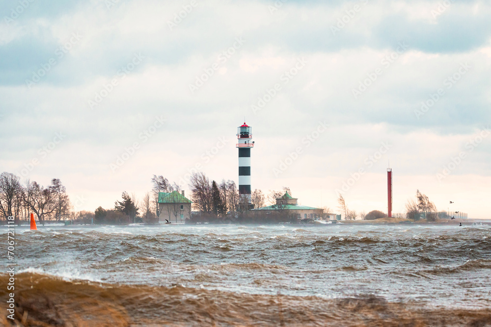 Fototapeta premium View to the Daugavgriva lighthouse from Mangalsala pier during stormy weather in Riga, Latvia