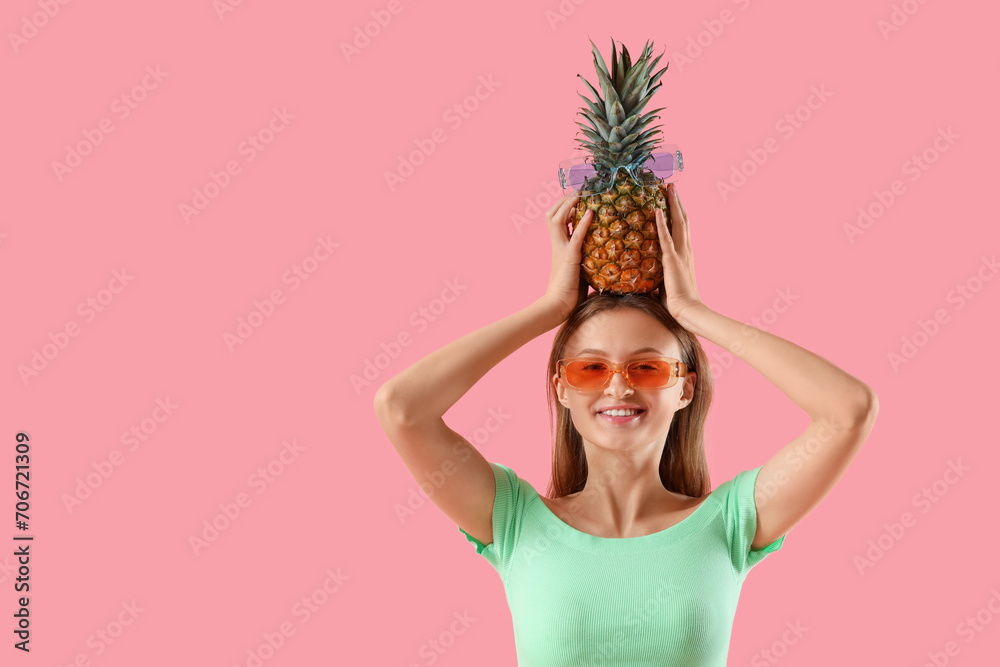 Pretty young woman with pineapple on pink background Pretty young woman with pineapple on pink background