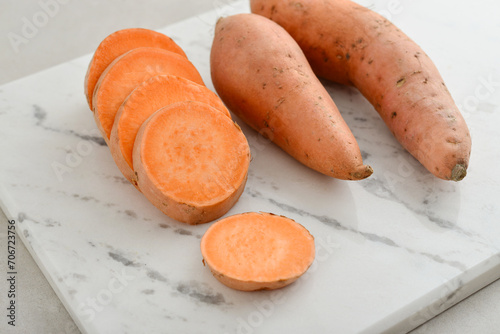 Set of fresh whole and sliced sweet potatoes
