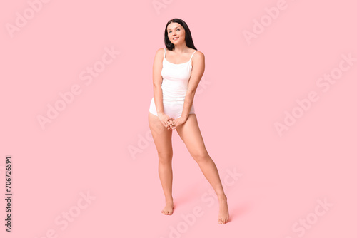 Body positive woman in underwear smiling on pink background © Pixel-Shot