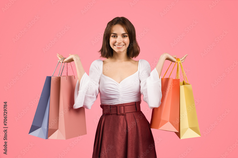 Smiling young woman in a stylish white blouse and maroon skirt, exuding happiness