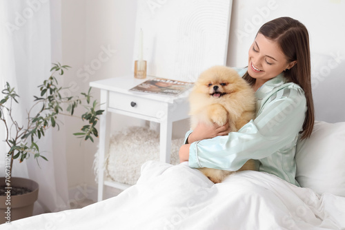 Happy young woman in pajama...