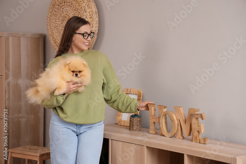 Young woman with cute Pomer...