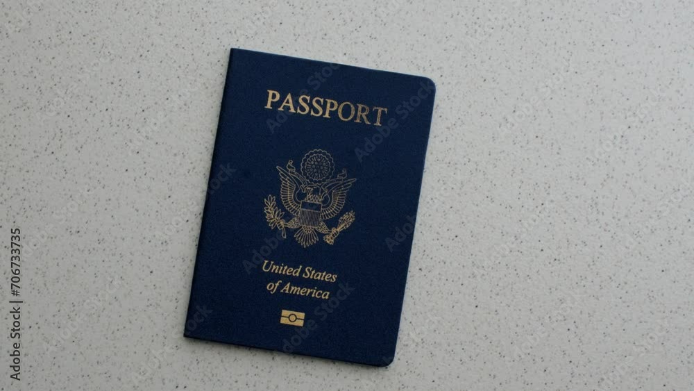 American Passport and Dollars: Fascinating detail of the US passport with dollar bills, symbolizing travel, exchange and money. American Passport and Dollars: Fascinating detail of the US passport with dollar bills, symbolizing travel, exchange and money.