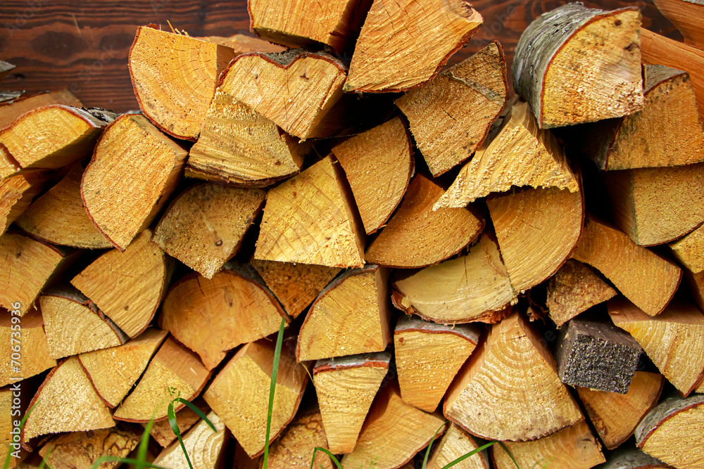 Stack of chopped firewood. Eco-friendly bio fuel. Woodpile near village house. Stack of chopped firewood. Eco-friendly bio fuel. Woodpile near village house.