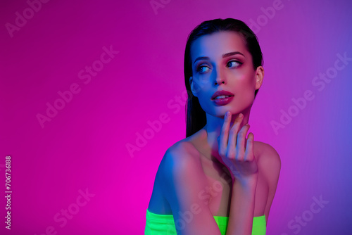 Photo of attractive tender gentle girl touch look neon vibrant empty space thinking choose promo offer
