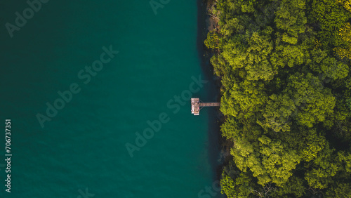 drone view of a wooden jetty in the Parana River during a sunset time. Panorama, Brazil