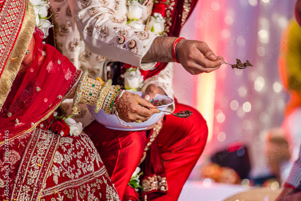 Indian Hindu wedding ceremony ritual items and hands close up
