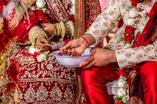 Indian Hindu wedding ceremony ritual items and hands close up