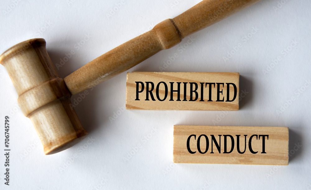 PROHIBITED CONDUCT - words on wooden blocks on a white background with a judge's gavel.