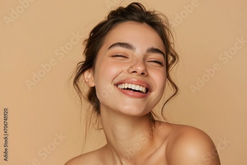 Young woman with a bright beauty smile  her face showcasing the results of a dedicated skincare regime  against a simple beige studio background  radiating happiness and confidence.