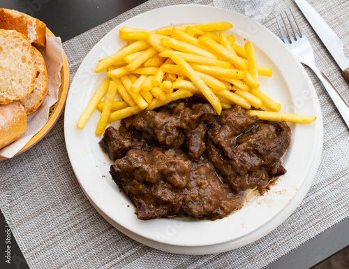 Appetizing French dish is Beef bourguignon, made from appetizing meat with wine and served with French fries