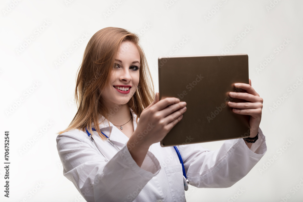 Smiling physician wields technology for patient wellness Smiling physician wields technology for patient wellness