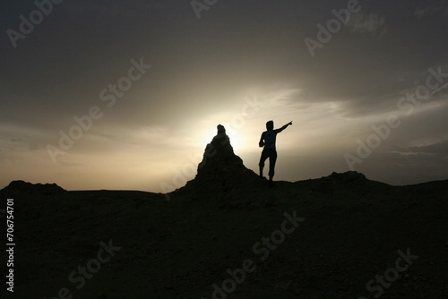 A tourist points to the sky near Ait Ben Haddou, Morocco, Africa photo
