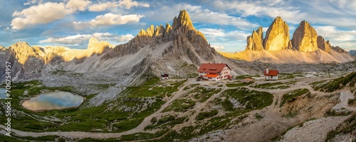 View of mountain hut Dreizinnenhuette and chapel with mountain lake rock massif Paternkofel and mountains three peaks in the sunset, panorama, Dolomites, South Tyrol, Italy, Europe
