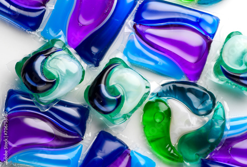 Washing capsules, colorful laundry pods. Colorful Soluble capsules with laundry gel detergent and dishwasher soap. Pile of various washing pod capsules. Detergent tablets. Top View, Flat Lay.  © Subbotina Anna
