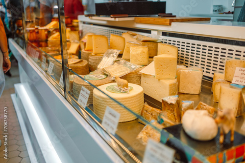 A large selection of different french and italian cheeses on display in a supermarket. Spain. High quality photo