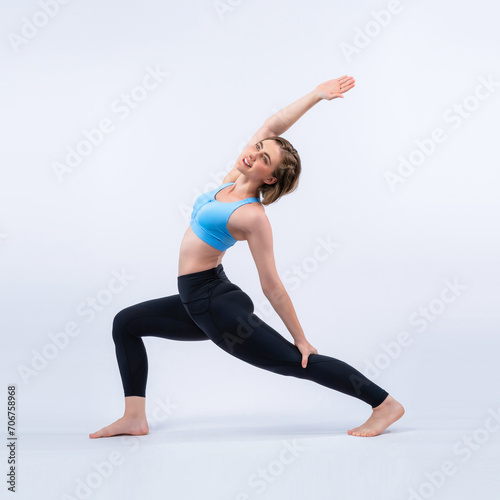 Full body length gaiety shot athletic and sporty woman doing healthy and meditative yoga exercise workout posture on isolated background. Healthy active and body care lifestyle