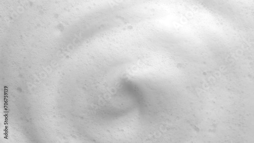 Foam background. Liquid soap bubbles, Froth bubbles backdrop. Soap foam popping bubble rotating, white backdrop. Soap sud macro structure close-up. Clean, cleaning, washing, laundry photo