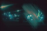 Bright lights of the night city, view of the park alley through the car glass through the refraction of light and fog