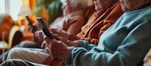 Multiracial senior friends with popcorns watching match over digital tablet in nursing home Wireless technology sport unaltered curiosity togetherness support assisted living and retirement photo
