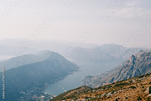 View from the mountain of the valley of the Bay of Kotor surrounded by a mountain range in a light haze. Montenegro