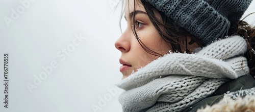 side view of young woman in winter clothes isolated on white background. with copy space image. Place for adding text or design