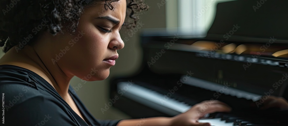 Fototapeta premium Plus size hispanic woman playing piano at music studio skeptic and nervous frowning upset because of problem negative person. with copy space image. Place for adding text or design