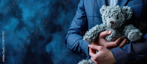 older man in suit snuggles with a stuffed animal blue suit pedophile. with copy space image. Place for adding text or design