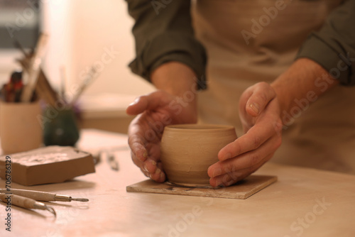Clay crafting. Man making bowl at table  closeup