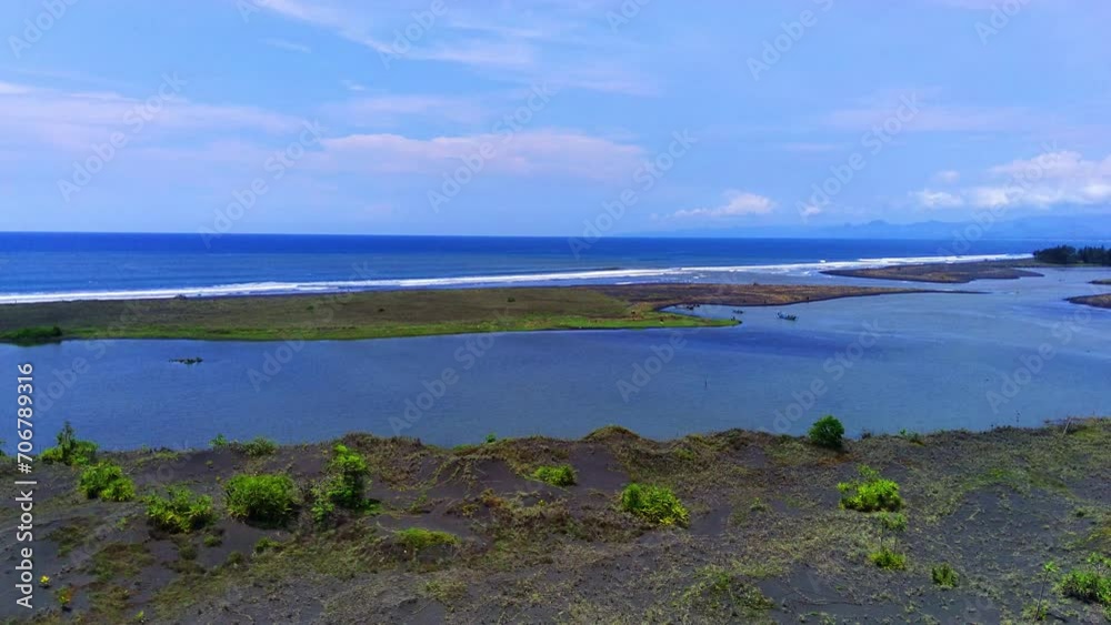 A serene seascape with a lush green island in Jember, East Java, Indonesia. A serene seascape with a lush green island in Jember, East Java, Indonesia.