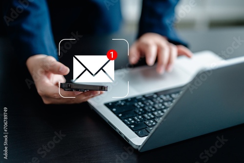 Businesswomen using smartphones check New email notifications and business digital online marketing. Inbox receiving electronic message alert. icon envelope virtual screen, communication technology. photo