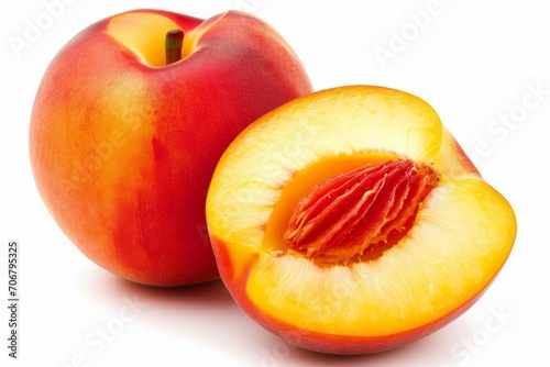 A peach and a half of a peach are displayed on a white surface, appearing fresh and juicy.