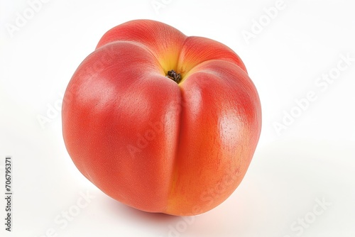 A peach, resembling a tomato, is displayed on a white surface. photo