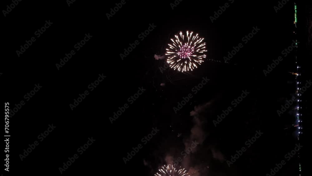 Fantastic fireworks festival at the end of the year near the seafront - vertical video Fantastic fireworks festival at the end of the year near the seafront - vertical video
