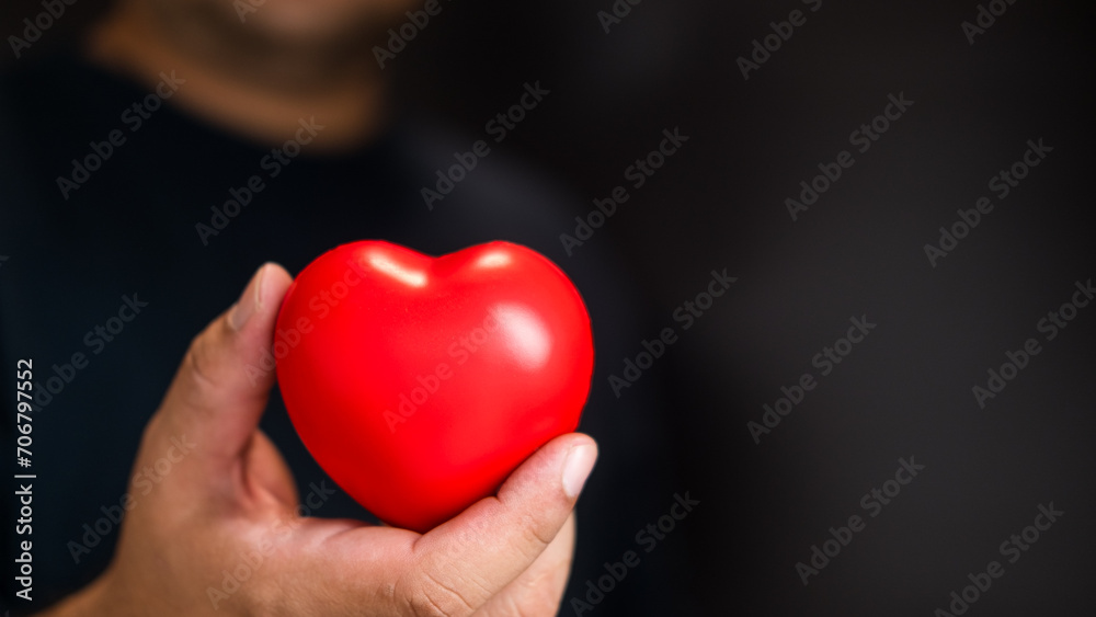 Man hand give red heart for love. Heart in hands Man hand give red heart for love. Heart in hands