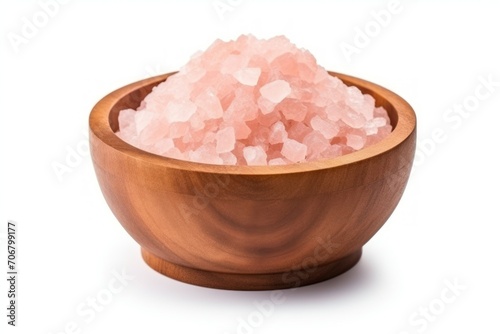 Pink Himalayan salt in a wood bowl isolated on white