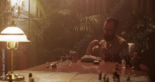 Wallpaper Mural Male perfumer smelling oil while working on perfume Torontodigital.ca