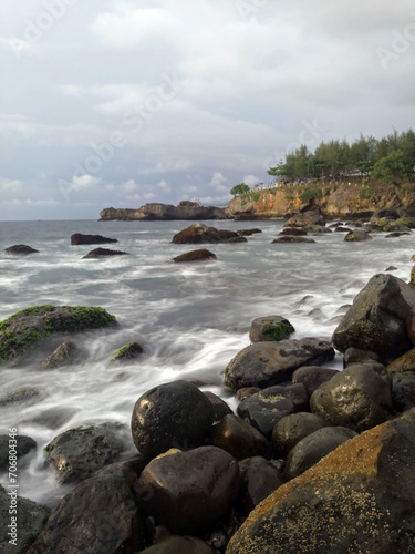 Long exposure of waves on rocky beach in East Java, Indonesia