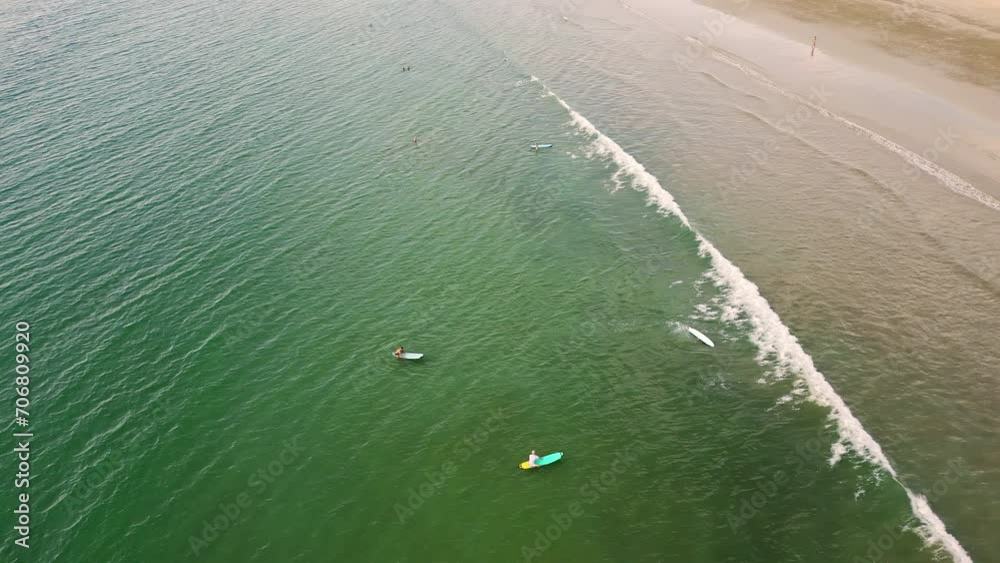 Aerial view of surfers waiting for waves off a warm, tropical beach in Thailand Aerial view of surfers waiting for waves off a warm, tropical beach in Thailand