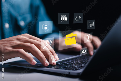 Businessman using laptop with virtual document management system for online document database and automated processes in file management, Search and manage document database files online.