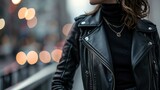 For a sleek and modern look, opt for a minimalist allblack ensemble featuring a leather moto jacket, black turtleneck sweater, black skinny jeans, and ankle boots.