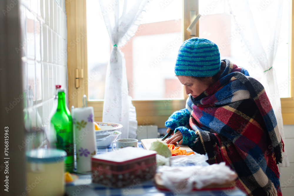 Mid Adult Female Unemployed Preparing herself a Poor Vegetable Meal in an Old Cold Apartment - Poverty Social Issues Mid Adult Female Unemployed Preparing herself a Poor Vegetable Meal in an Old Cold Apartment - Poverty Social Issues